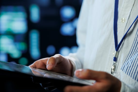 engineer-data-center-using-tablet-prevent-system-overload-close-up-employee-server-room-ensuring-there-is-enough-network-connectivity-smooth-operations-blurry-background