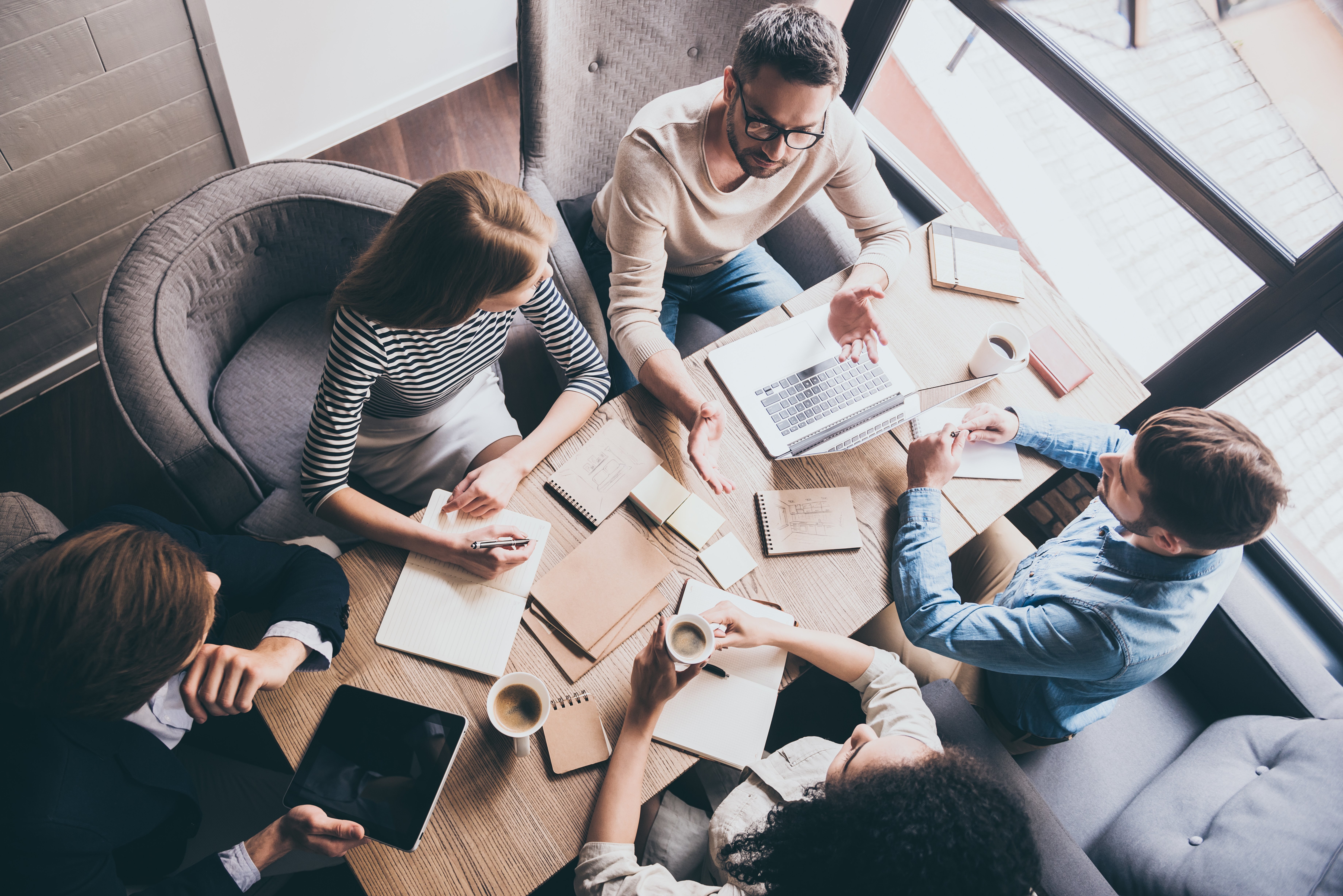 business-meeting-top-view-buiness-team-brainstorming-while-sitting-office-table-together