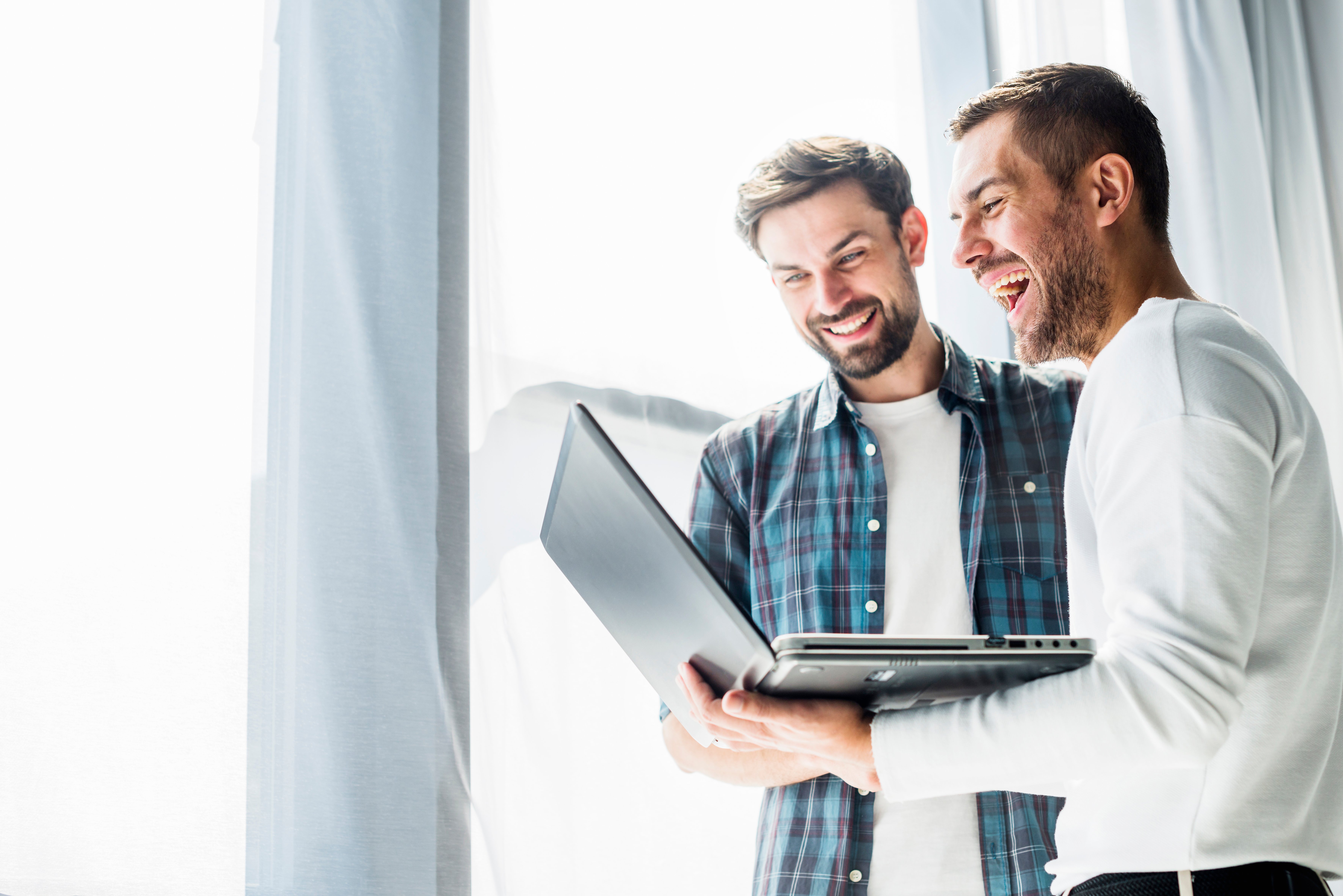 two-happy-businessman-working-laptop