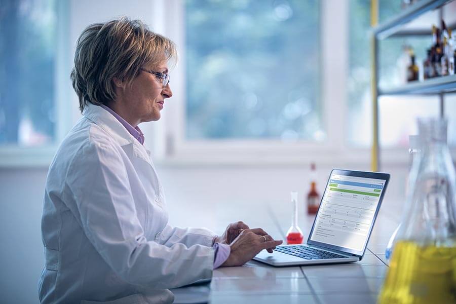 Laboratories_Woman-in-lab-with-BizzMine-laptop